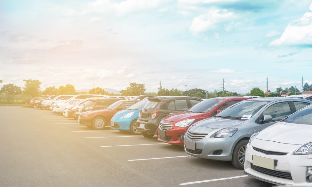 Car,Parking,In,Large,Asphalt,Parking,Lot,With,Trees,,White